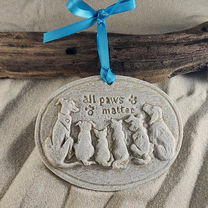 Three dogs and two cats on oval sand ornament with the words "All Paws Matter" above them with paw prints, can order with glitter and ribbon or no glitter and a jute tie for a more coastal look