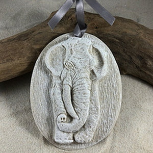 Elephant ornament. With his ears spread wide and his trunk hung low, this elephant ornament is a one-of-a-kind three-dimensional sand ornament. REAL SAND is used to create each beach ornament. 