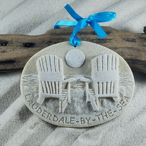 Lauderdale by the Sea gift idea.  Real sand is used to create these Adirondack beach chairs just waiting to watch the sunset sand ornament.  Whitewashed, glittered and along the bottom edge it is engraved into the sand Lauderdale-by-the-Sea. Attached is a turquoise bowed ribbon for hanging and a tag indicating that it is handcrafted with sand and made in Florida.