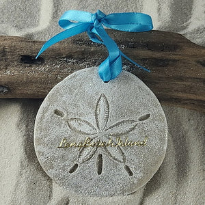 Long Beach Island gift idea.  Real sand is used to create this sand dollar ornament.  it is whitewashed, glittered and in the center are gold scripted lettering reading Isle of Palms.  Attached is a pretty turquoise bowed ribbon for hanging and a tag indicating that it is handcrafted with sand and made in the USA.